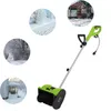 A collage showing a green electric snow blower with four circular inset images depicting snowy scenes: a road through a snowy forest, a log cabin in the snow, a snowy path with trees, and a house porch in the snow. Podgląd zdjęcia produktu