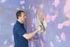A man is plastering a wall with a trowel. Produktbild-Vorschau