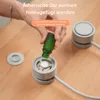 A person is shown adding essential oil to a small, gray aromatherapy diffuser with a fan. Náhľad obrázku produktu