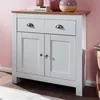 A white sideboard with a wooden top is shown against a pink wall. Voir les images du produit