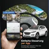 A hand holding a smartphone displaying a dashcam app, with a car and scenic road views in the background. Produktbild-Vorschau