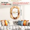 A decorative mirror is mounted on a wall above a sofa with several pillows. Produktbild-Vorschau