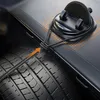 A car phone holder is shown attached to a car's dashboard, with a tire visible in the foreground. Náhled obrázku produktu