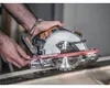 A person is using a cordless circular saw to cut a piece of wood. Náhled obrázku produktu