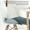 A person is sitting on a chair with a seat cushion, demonstrating its use. Produktbild-Vorschau