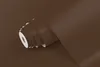 A roll of brown matte adhesive film is shown from the side, partially unrolled. Produktbild-Vorschau
