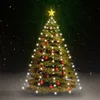 A decorated Christmas tree with lights and ornaments, set against a dark, snowy background. Produktbild-Vorschau
