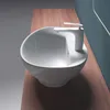 A white ceramic sink with a modern white faucet sits on a wooden countertop. Produktbild-Vorschau