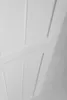 A close-up, abstract view of a white cabinet or furniture piece with paneling details. Podgląd zdjęcia produktu