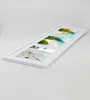 A white collage picture frame with three beach-themed photos displayed at an angle on a light gray surface. Produktbild-Vorschau