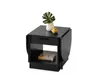 A black side table with a drawer and a shelf, decorated with a plant in a vase and a small yellow object. Náhľad obrázku produktu