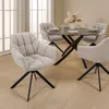 A dining set with a round table and four chairs in a room with natural light. Produktbild-Vorschau