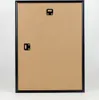 The back of a black picture frame with hanging hardware. Produktbild-Vorschau