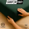 Hands touching a dark green fabric, likely a fitted sheet, with a wooden floor in the background. There are also icons and text overlays. Produktbild-Vorschau