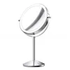 A silver, double-sided makeup mirror with LED lighting on a stand, shown against a white background. Produktbild-Vorschau