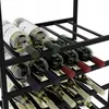 A close-up view of a black metal wine rack filled with wine bottles. Podgląd zdjęcia produktu
