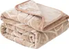 A folded beige blanket with a textured pattern. Podgląd zdjęcia produktu