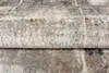 A close-up view of a folded rug with a textured, abstract pattern in shades of gray, beige, and cream. Anteprima dell’immagine prodotto