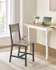 A modern chair placed in front of a desk with a laptop and flowers. Náhled obrázku produktu