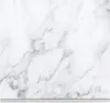 A close-up, top-down view of a white marble pattern. Anteprima dell’immagine prodotto