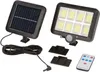 A solar-powered spotlight with a separate solar panel, remote control, and mounting brackets. Produktbild-Vorschau