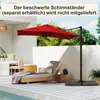A red cantilever umbrella is set up on a patio next to a lounge chair and a small table, with a swimming pool in the foreground. Náhled obrázku produktu