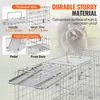 A diagram and close-up shots of a metal animal trap, with a blurred image of a raccoon in the background. Produktbild-Vorschau