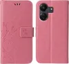 A pink flip phone case with floral and butterfly embossing is shown open, displaying the inside and the outside of the case. Produktbild-Vorschau