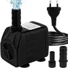 A black submersible water pump with water spraying from the top, a power cord with a European plug, and two nozzle attachments. The pump is shown on a white background. Produktbild-Vorschau