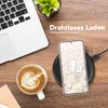 A desk scene with a laptop, coffee, and a smartphone charging wirelessly. Produktbild-Vorschau