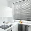 A clean, modern kitchen counter with a stovetop, cabinets, and a window with blinds. Produktbild-Vorschau