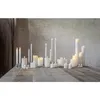 A collection of LED candles of various sizes and textures arranged on a wooden table. Podgląd zdjęcia produktu