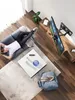 A person relaxing on a couch in a modern living room, watching TV mounted on a wall. Náhľad obrázku produktu