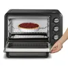 A toaster oven with a pie inside, and a hand opening the oven door. Voir les images du produit