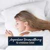 A woman sleeping peacefully on a white pillow, with a text overlay promoting a comfortable cotton cover for restful sleep. Produktbild-Vorschau