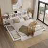 A bedroom scene featuring a white bed with storage drawers, a headboard with shelves, and a bedside table.