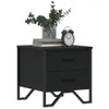 A black nightstand with two drawers is shown against a white background. A vase with greenery, a stack of books, and an alarm clock are placed on top of the nightstand. Náhľad obrázku produktu