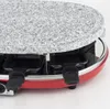 Close-up of a red raclette grill with a granite top and black pans. Produktbild-Vorschau