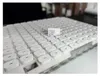 A large quantity of white USB-C chargers are neatly arranged in rows, with one charger placed on top of the others. Anteprima dell’immagine prodotto
