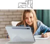 A young girl is using a tablet with a white case while doing homework. Voir les images du produit