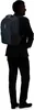 A person wearing a suit and carrying a backpack. Produktbild-Vorschau