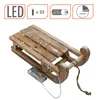 A decorative wooden sled with LED lights. Voir les images du produit