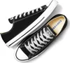 A pair of black Converse All Star low-top sneakers with white laces and soles, presented on a white background. Voir les images du produit