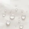 Close-up of water droplets on a white fabric surface. Náhľad obrázku produktu