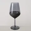 A single wine glass with a dark gray tinted bowl and a black base, set against a plain background. Náhled obrázku produktu