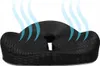 A black orthopedic seat cushion with blue wavy lines indicating airflow. Podgląd zdjęcia produktu