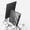 Two iPad cases are shown, one in the foreground and one in the background, with shattered glass elements around them. Produktbild-Vorschau