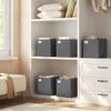 Storage boxes are neatly arranged on shelves in a closet. Produktbild-Vorschau