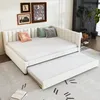 A beige upholstered daybed with a pull-out trundle bed is set up in a room with artwork on the wall and a plant in the background. Náhľad obrázku produktu