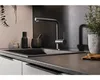 A modern kitchen sink area with a faucet, mortar and pestle, and a potted plant. Anteprima dell’immagine prodotto